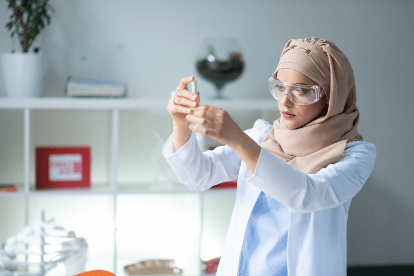 Female scientist holding a syringe to extract a liquid