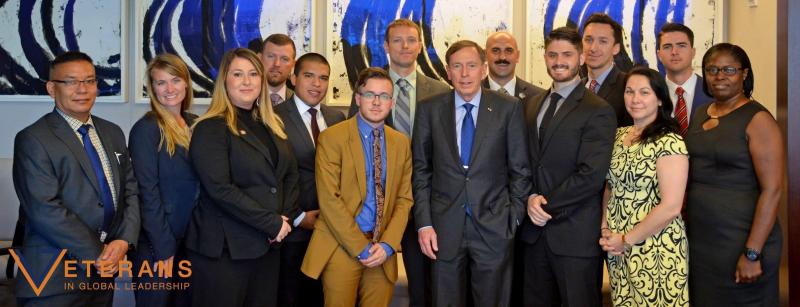 Veterans in group photo smiling for a Veterans in Global Leadership Fellowship photo. 