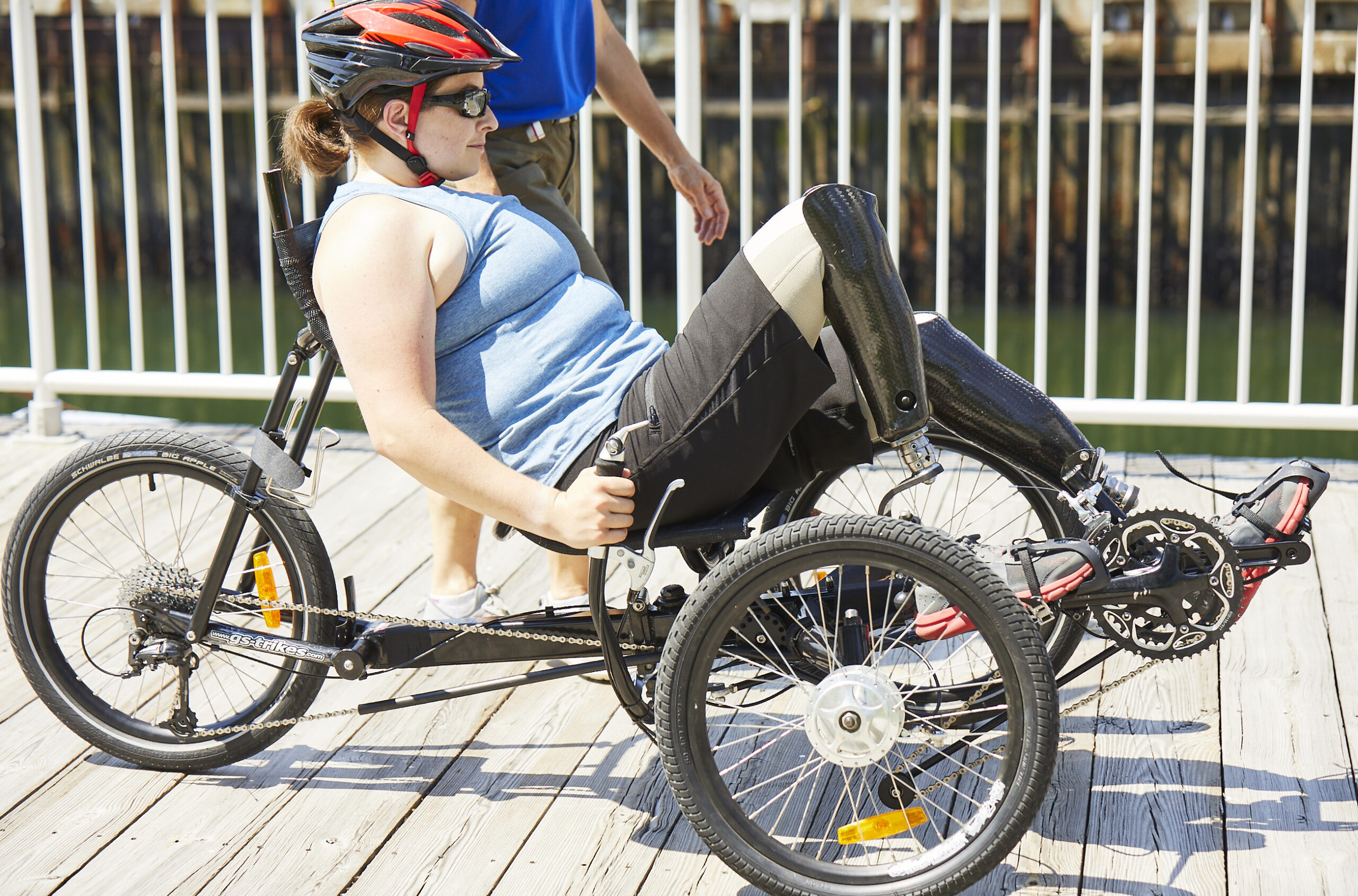 Woman cycling with prosthetic legs