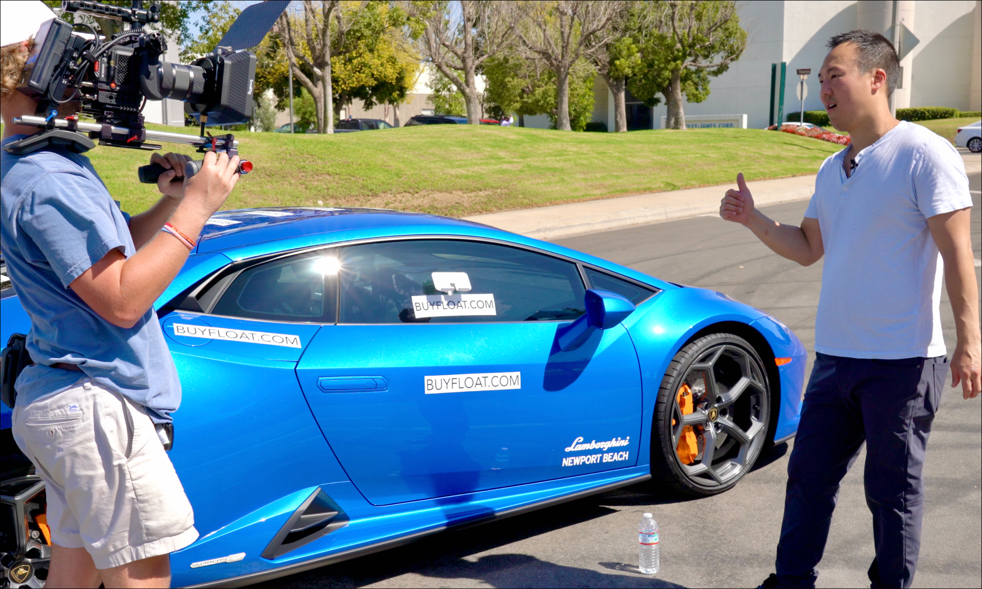 YJ Heo being interviewed prior to product testing FLOAT on a bright blue Lamborghini supercar.