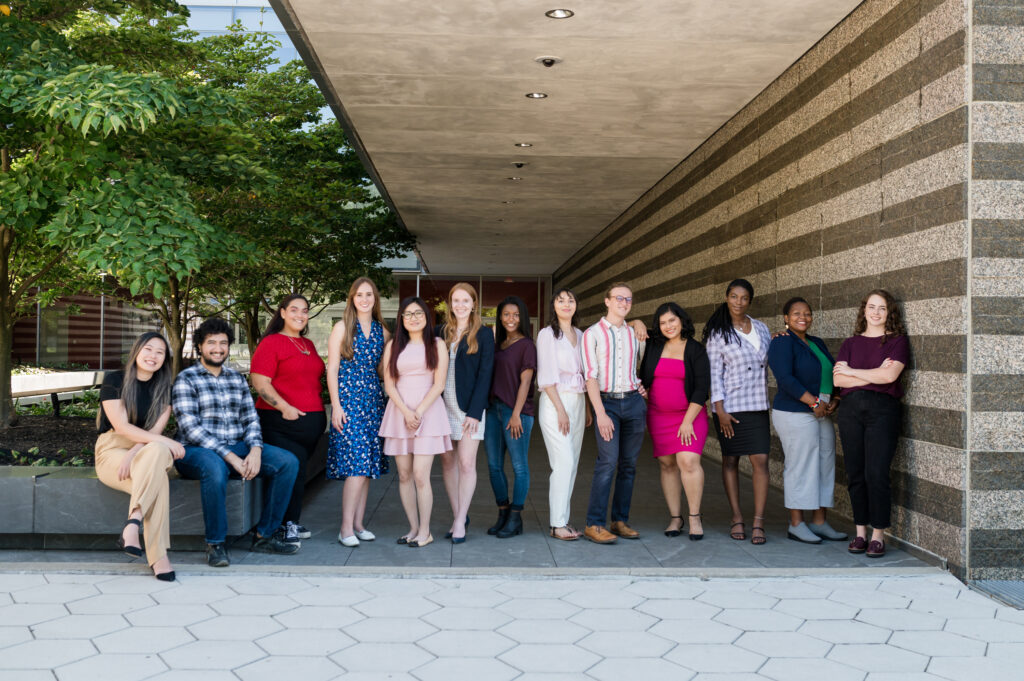 Young professionals from the Cleveland Foundation Public Service Fellowship stand in front of the entrance of the Cleveland Museum of Art