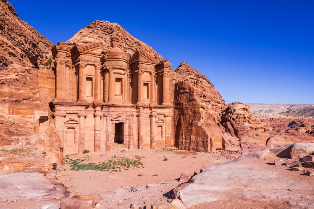 The stunning view of Ad Deir, the Monastery of Petra, Jordan on a clean blue sky spring day.