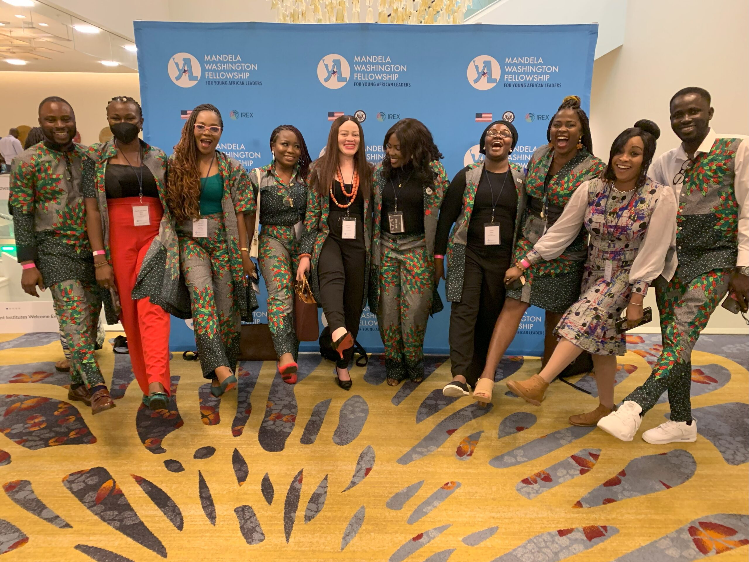 Racheal Inegbedion posing with other Nigerian Mandela Washington Fellows in front of a blue banner in Washington DC.