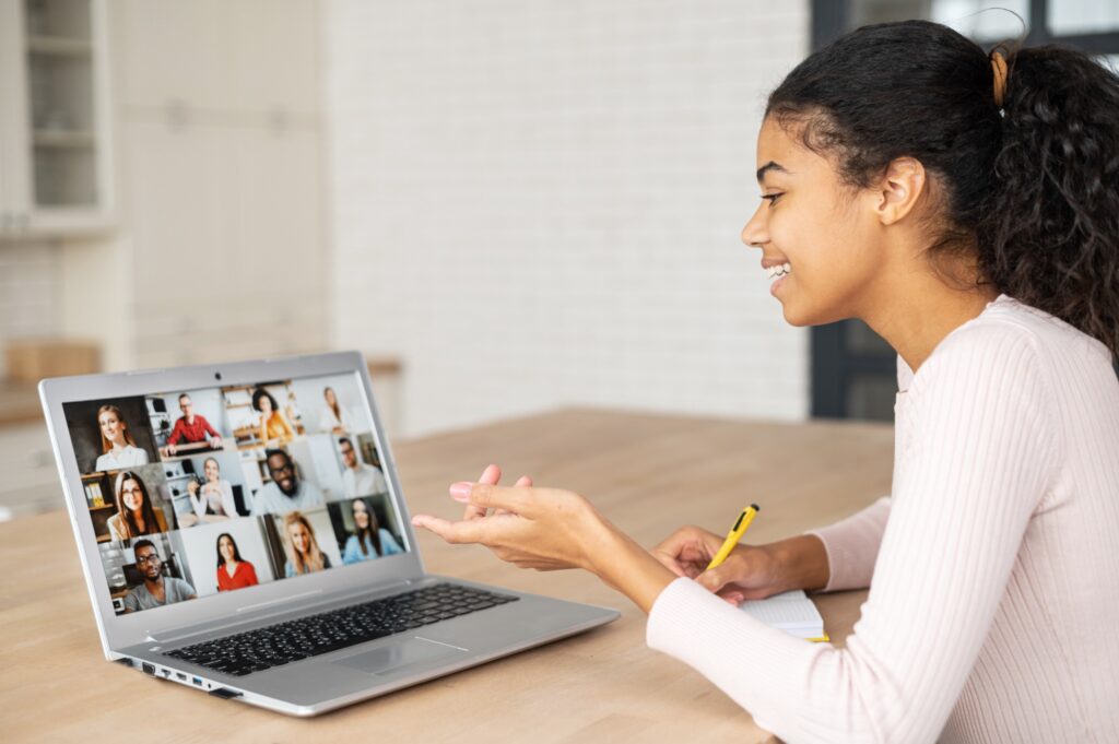 African American female undergraduate student participating in a remote fellowship for undergraduate students in which multiple fellows are participating via Zoom video.