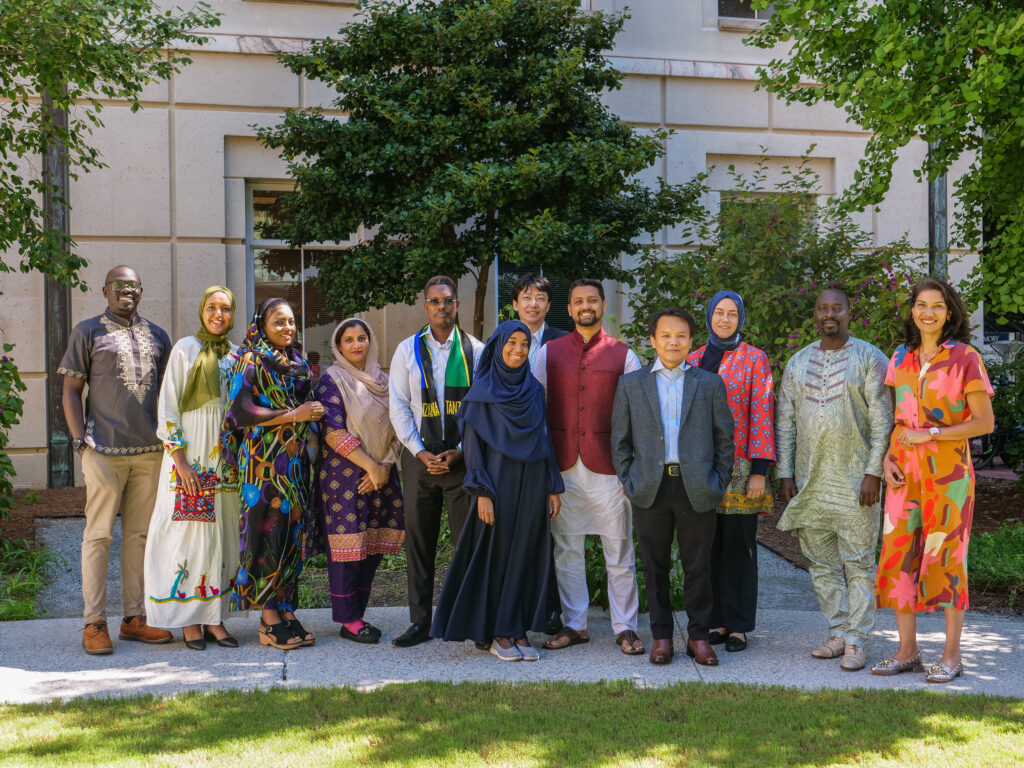 Monzur Morshed Patwary, wearing traditional maroon and white clothing, standing center with eleven others in his cohort for the 2022-2023 Hubert H. Humphrey Fellowship at Emory University.