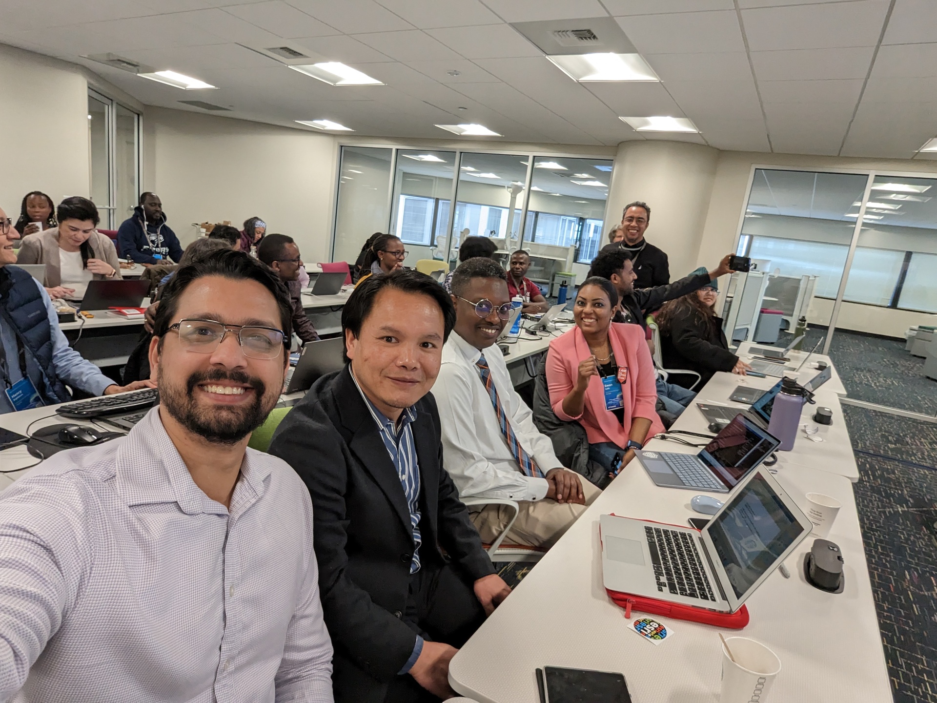 Monzur Morshed Patwary, taking the picture, with other fellows in his cohort attending training in Washington D.C., as part of the fellowship. Fellows are sitting at rows of longs desks with computers and an instructor walks around checking on them.