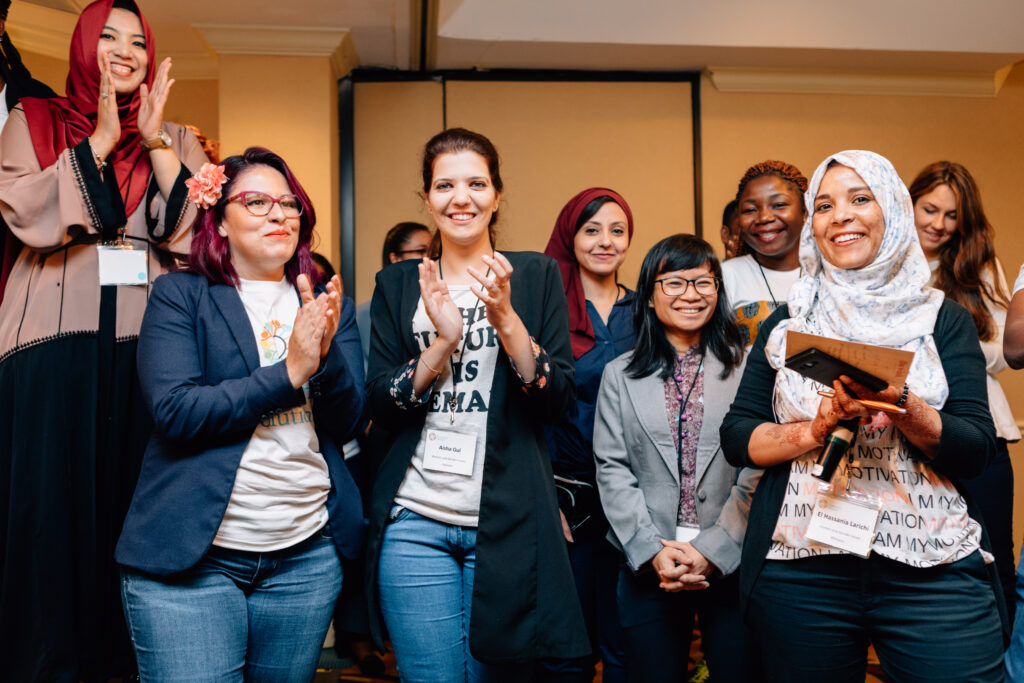 A group of fellowship alumni applauding at IREX's Community Solutions Program Orientation Conference in 2018.