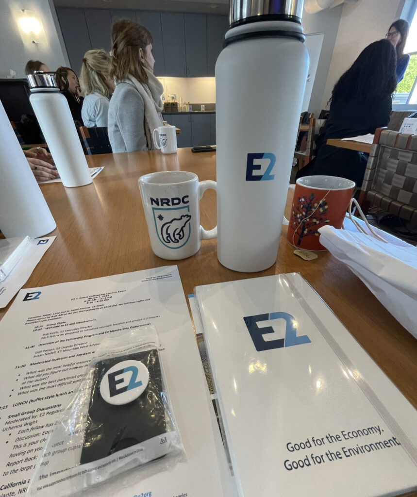 Desk with water bottle, brochure, mug, emblazoned with E2 and NRDC logos