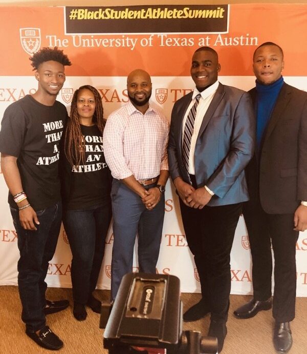 Dr. Nita Evans stands next to her son, a college athlete, as well as his coach and two fellow athletes, at the University of Texas at Austin Black Student Athlete Summit.