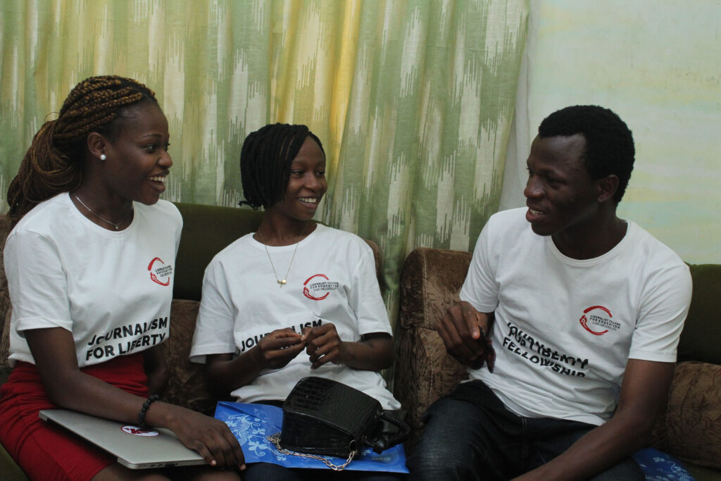 Favour and two of her cohort members sit on a couch, discussing.