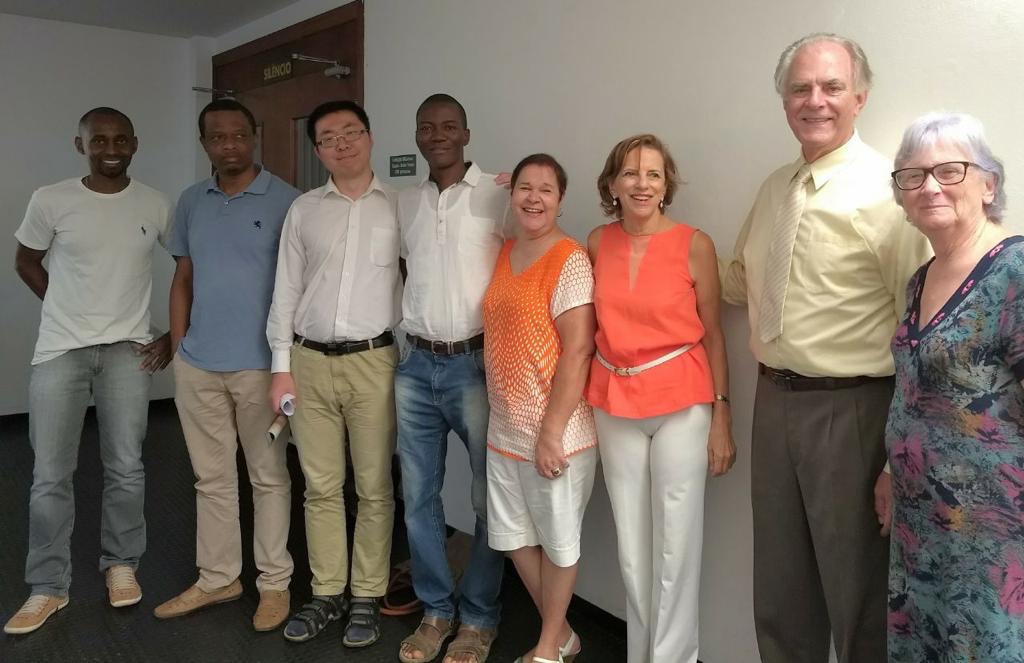 Chinedu, wearing a blue polo stands second farthest to the left, surrounded my friends and family friends in Brazil.