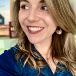 Dr. MK Foster's headshot image. She is smiling, looking to the left. Wearing a blue top.